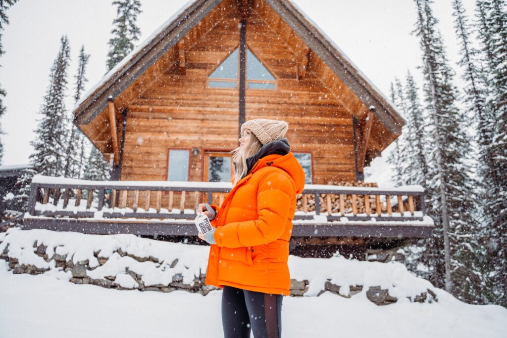 Woman standing in front ouf house in winter